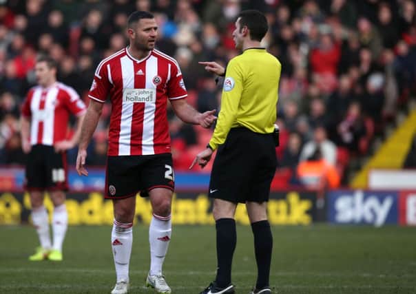 Michael Higdon, Sheffield United, has a few words with referee David Couts