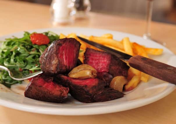 Hanger steak with slow roasted cherry tomatoes, confit of garlic and a rocket salad. Picture Tony Johnson