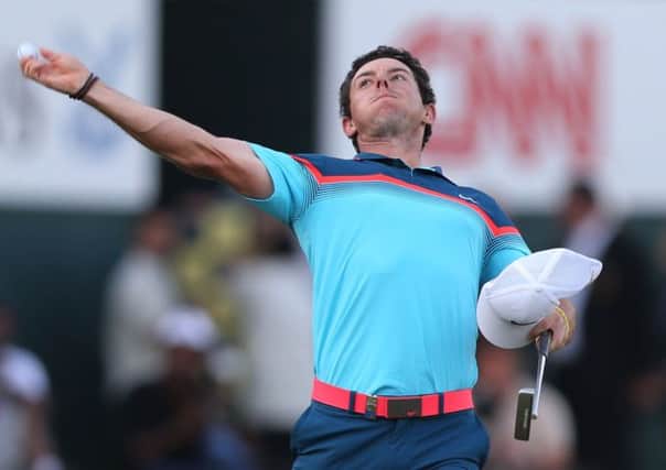 Rory McIlroy throws his ball to the crowd.