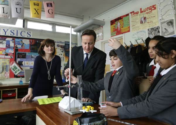 David Cameron and Education Secretary Nicky Morgan in a science classroom at Kingsmead School in Enfield, London.