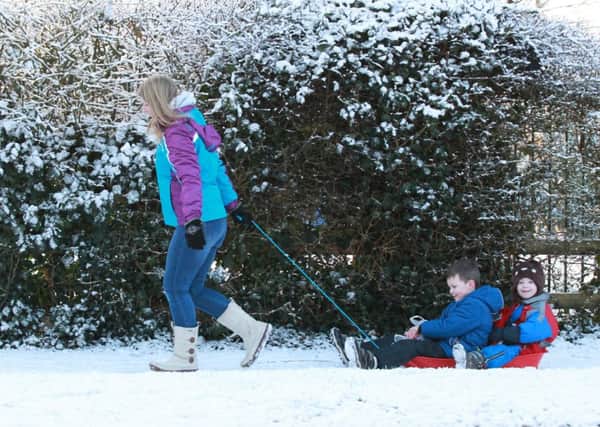 A woman pulls her two young children to school in a sled after heavy snow overnight in Pocklington in East Yorkshire.  Picture: Ross Parry Agency