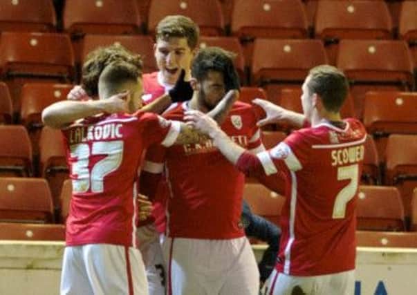 Barnsley players congratulate Kane Hemmings for his match-winning goal against Oldham at Oakwell (Picture: Dean Atkins).
