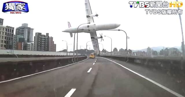 A commercial aeroplane clipping an elevated roadway just before it careened into a river in Taipei, Taiwan