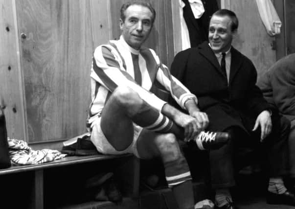 Stanley Matthews laces up his boots for what would be his final match at the age of 50 on February 6, 1965. (PA Wire).