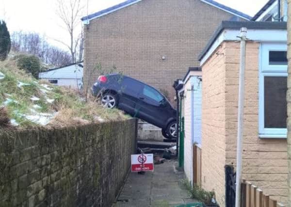 The black Audi A3 which crashed into a house in Todmorden.  Pictures: Ross Parry Agency