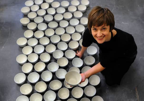 Artist Clare Twomey  with some of the 10,000 ceramic bowls  being made by Mixed Art and Design students at York College