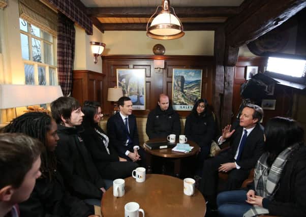George Osborne and David Cameron speak to apprentices in The Woolpack pub, during a visit to the set of Emmerdale on the Harewood Estate near Leeds.