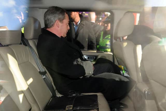 UKIP leader Nigel Farage sits in the car as he leaves the UKIP office in Rotherham.