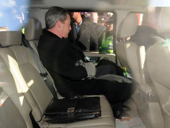 UKIP leader Nigel Farage sits in the car as he leaves the UKIP office in Rotherham.