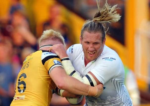 Huddersfield Giants' Eorl Crabtree charges past Castleford Tigers' Oliver Holmes