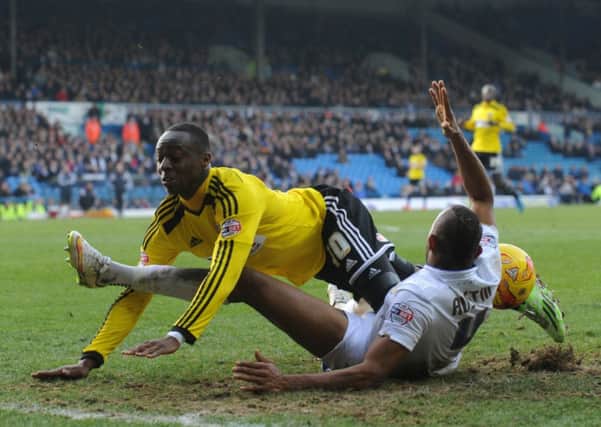 Rodolph Austin is taken down just in the penalty box by Mose Odubajo but no penalty was given by referee Graham Salisbury (Picture: Bruce Rollinson).