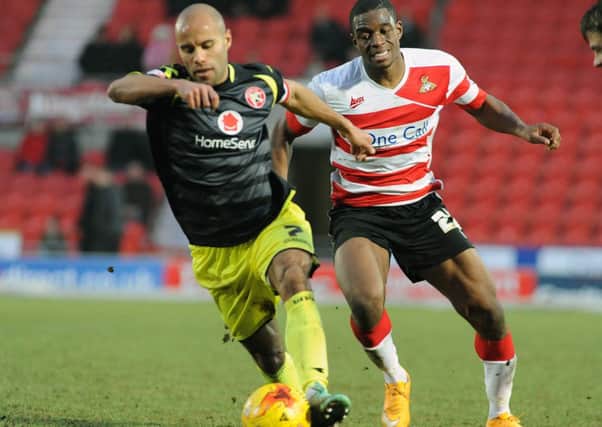 Walsall defender and captain Adam Chambers gets away from Doncaster's Uche Ikpeazu