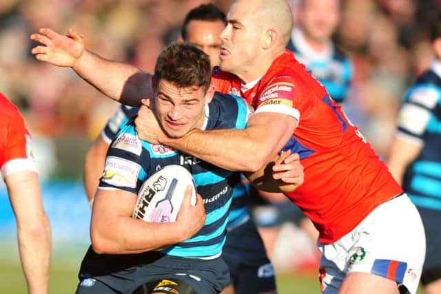 Rhinos' Stevie Ward tackled by Hull KR's Terry Campese. (Picture: Tony Johnson)