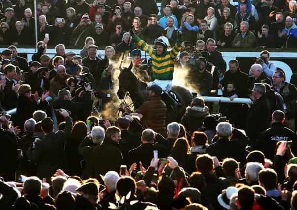 AP McCoy acknowledges the cheers of the crowd as he enters the parade ring aboard Carlingford Lough after winning the Hennessy Gold Cup at Leopardstown yesterday. On Saturday, he announced he is to retire in April (Picture: Brian Lawless/PA).