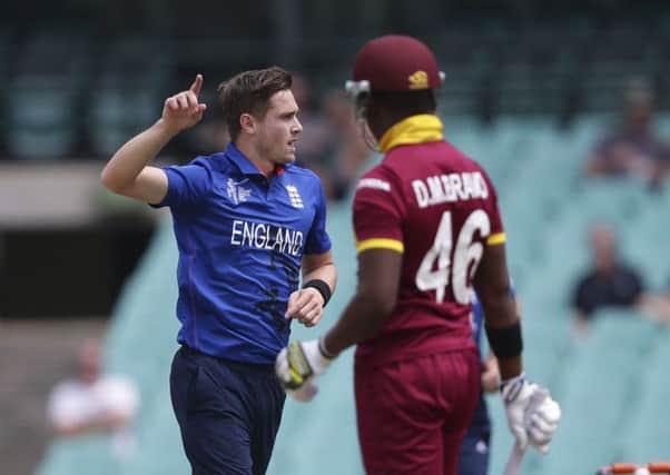 England bowler Chris Woakes left, raises his arm as he celebrates taking the wicket of West Indies batsman Darren Bravo during their Cricket World Cup warm-up match in Sydney.(AP Photo/Rob Griffith)