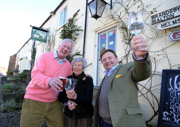 Robert Turl from Easingwold raising a glass alongside Micky Johnson from Tollerton and landlord of Durham Ox Michael Ibbotson.