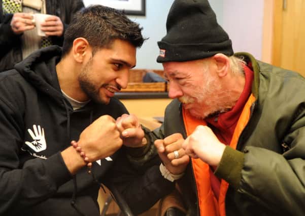 Boxer Amir Khan meets Phillip John Gillan during a visit to St George's Crypt, Leeds. PIC: Steve Riding