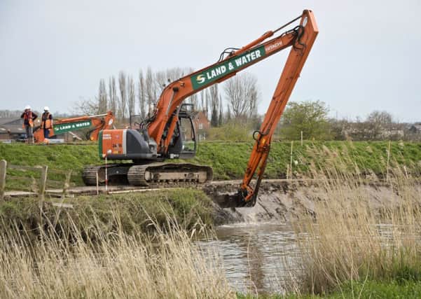 Dredging taking place on the River Parrett, near Burrowbridge in Somerset, as MPs warned that it will be "difficult" to raise hundreds of millions of pounds from private sources to help pay for flood defences over the next six years.