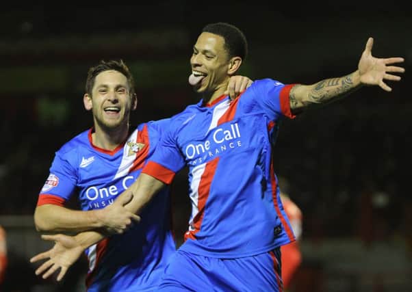 Nathan Tyson, right, celebrates scoring Doncaster Rovers' third goal at Crawley last night (Picture: Howard Roe/AHPIX.com).