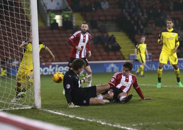 Jose Baxter slides home Sheffield United's opener against Colchester. (Picture: Martyn Harrison).