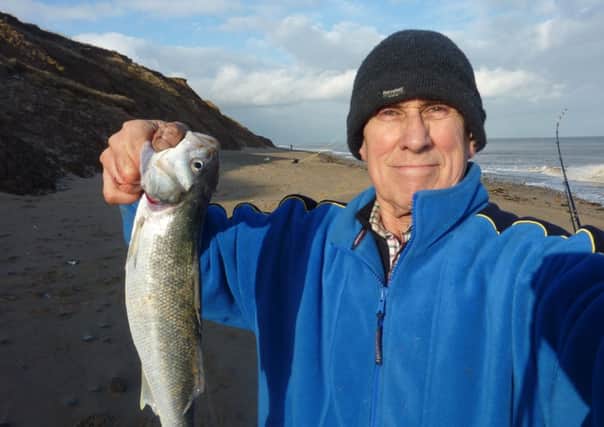 Stewart Calligan with the sea bass he caught at Spurn.