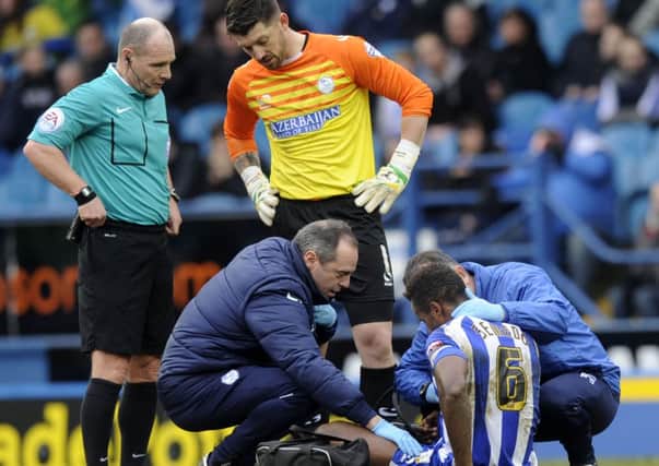 Sheffield Wednesday midfielder Jose Semedo is treated for an ankle injury against Brighton (Picture: Steve Ellis).