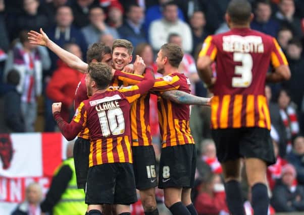 Jon Stead smiles as Bradford City team-mates mob him after he had scored the second goal in the League One sides 2-0 FA Cup fifth-round win over Premier League Sunderland at Valley Parade yesterday (Picture: Jonathan Gawthorpe).