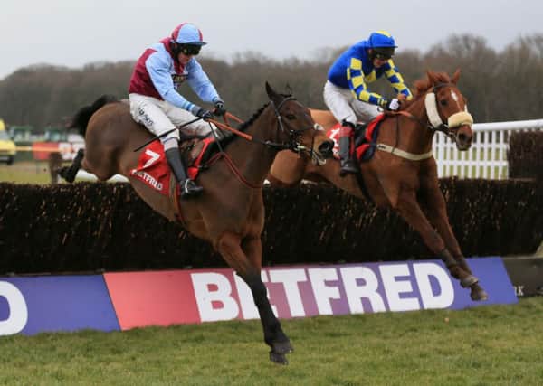 Lie Forrit (near side), ridden by Peter Buchanan jumps the last fence to win The Betfred Grand National Trial ahead of Harry The Viking (Derek Fox) in second during the Betfred Grand National Trial day at Haydock Park racecourse.