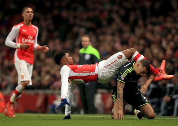 Arsenals Chuba Akpom and Middlesbroughs Ryan Fredericks, right, collide during a duel yesterday (Picture: John Walton/PA).