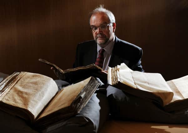 Professor Mark Ormord looking at accounting documents from the 15th -16th century