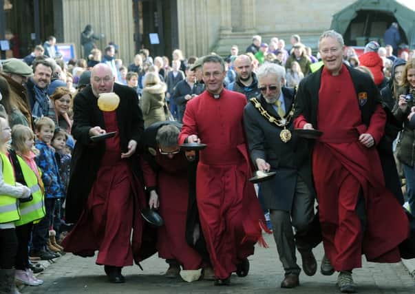 Dean of Ripon Cathedral John Dobson (centre) and the Mayor of Ripon Cllr Mick Stanley outside the Cathedral yesterday for the annual Shrove Tuesday pancake race.