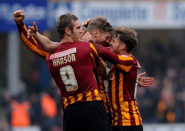 Bradford City's Jon Stead (centre) celebrates with James Hanson (left) and Billy Clarke after scoring his side's second goal during the FA Cup Fifth Round match at Valley Parade