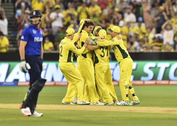 FRESH APPROACH: England's Jos Buttler walks off as Australia's players celebrate his dismissal during Saturday's World Cup opener.