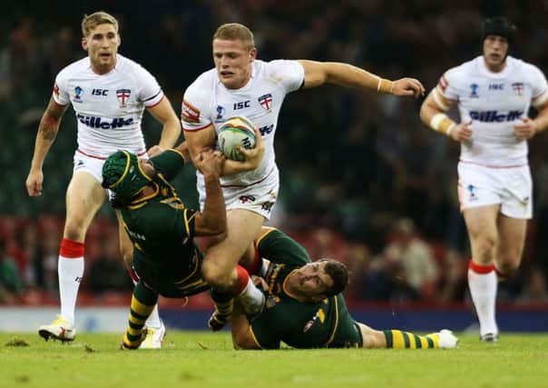 England's George Burgess is tackled by Australia's Cooper Cronk and Greg Bird (right) during the 2013 World Cup match at the Millennium Stadium, Cardiff.
