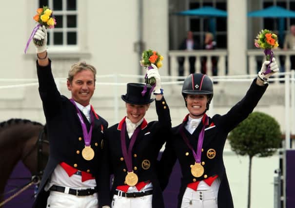 GOLDEN DAYS: Great Britains Carl Hester, left, Laura Bechtolsheimer and Charlotte Dujardin celebrate winning gold at London 2012.