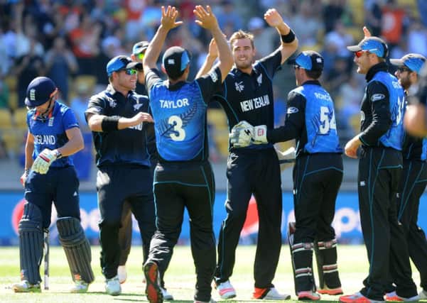 New Zealand bowler Tim Southee, centre, is congratulated by team-mates after dismissing England's James Taylor, left. Picture: AP /Ross Setford.