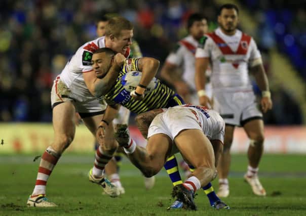 Warrington's Kevin Perry is tackled by St George-Illawarra's Joel Thompson and Tyson Frizell at the Halliwell Jones Stadium, Warrington. PRESS ASSOCIATION Photo. Picture: Mike Egerton/PA.