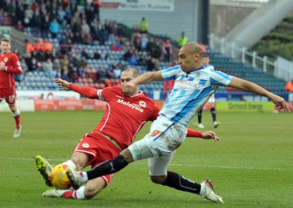 James Vaughan, of Huddersfield, shoots against Cardiff City.