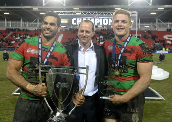 South Sydney Rabbitohs' George Burgess (right) Greg Inglis (left) and head coach Michael Maguire pose with the World Club Series trophy after the World Club Series match at Langtree Park, St Helens.