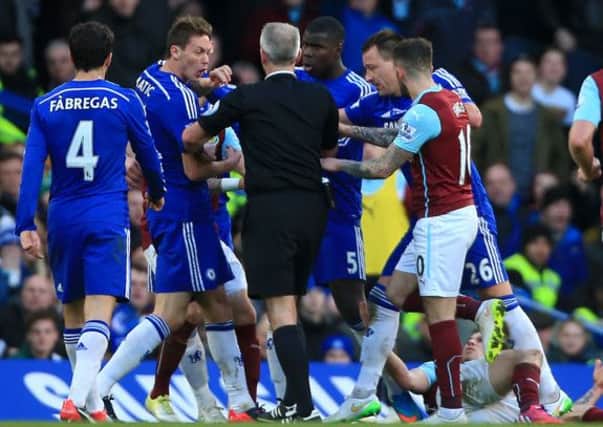 Chelsea's Nemanja Matic, second left, reacts angrily following a challenge by Burnley's Ashley Barnes (Picture: Nick Potts/PA).