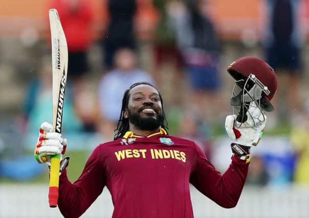 West Indies batsman Chris Gayle celebrates after scoring a double century during their Cricket World  Cup Pool B match against Zimbabwe. (AP Photo/Rob Griffith)
