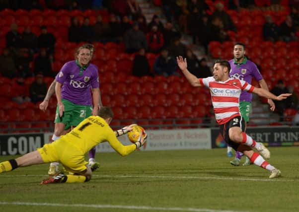 Doncaster Rovers' Dean Furman goes in looking for a possible fumble from goalkeeper Frank Fielding (Picture: Howard Roe).