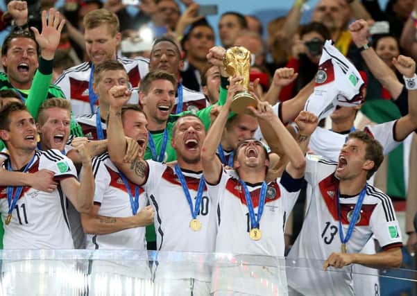 Germany's Philipp Lahm lifts the World Cup trophy as he celebrates winning the World Cup in Brazil.