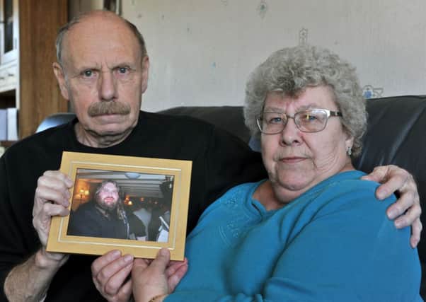 John and Patricia Wood, from Garforth, with a picture of their late son Darren. Picture by Bruce Rollinson.