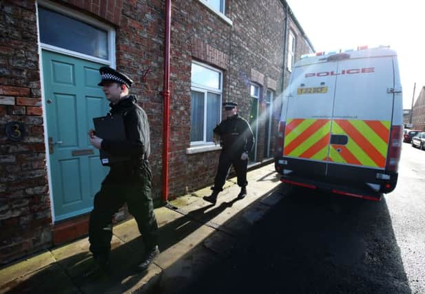 Police officers investigating the disappearance of chef Claudia Lawrence search a lane near her home on Heworth Road in York.