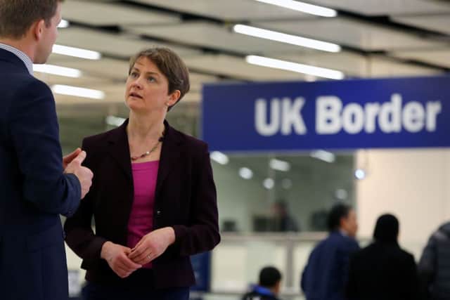 Shadow Home Secretary Yvette Cooper talks to an official at Gatwick Airport