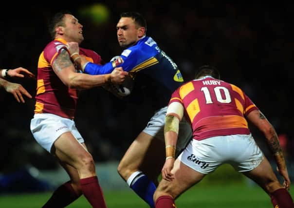 Rhinos' Kevin Sinfield is tackled by Giants' Craig Huby and Shaun Lunt. 
(Picture: Jonathan Gawthorpe).