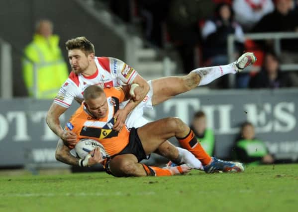 Tigers' Jordan Tansey is tackled by Tommy Makinson.