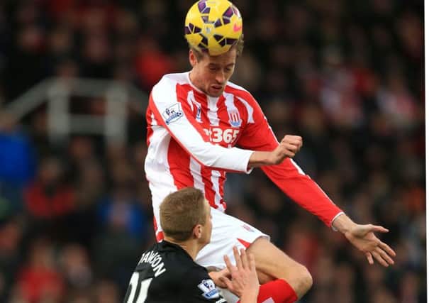 Stoke City's match-winner Peter Crouch rises way above Hull City defender Michael Dawson at the Britannia Stadium (Picture: Mike Egerton/PA).