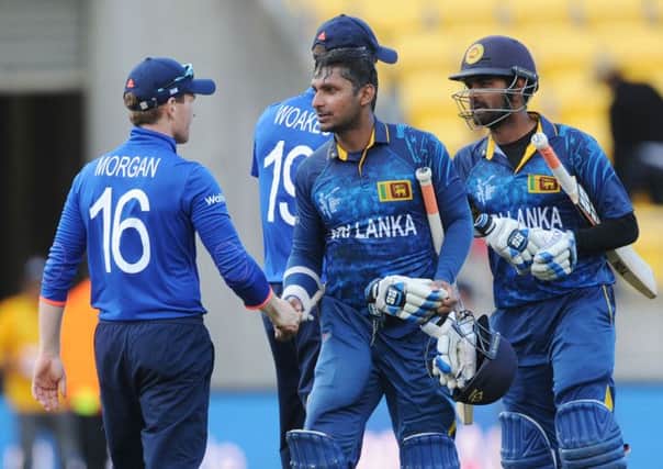 THANKS: Sri Lanka's Kumar Sangakkara, second left, and teammate Lahiru Thirimanne, right, shake hands with England captain Eoin Morgan left, after their nine-wicket win in Wellington. Picture: AP.